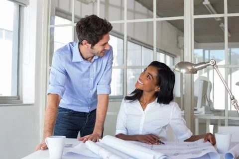 Architects communicating happily about work Foto stock