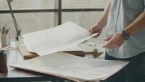 Architects designing a building with a ruler, pencil and other equipment. 스톡 동영상 336573671