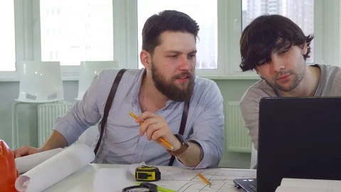 Architects discuss something on laptop Stock-Footage 73911655