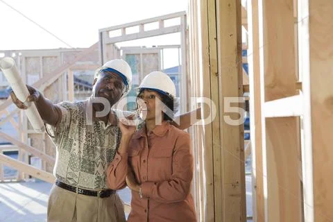 Architects Discussing Plans On Site Stock Photos