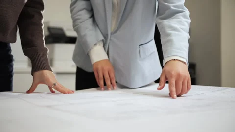 Architects discussing project plans over architectural drawings Stock Footage 326234508
