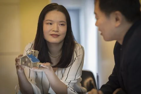 Architects discussing tiny house model in office meeting Foto stock