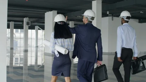 Architects with drafts inspecting constructions Stock Footage 125713683