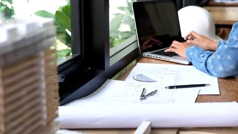 Architects engineer discussing at the table with blueprint Stock Footage 80075588