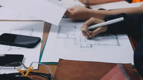 Architects engineer discussing at the table with blueprint - Closeup on han.. Stock Footage 333827726