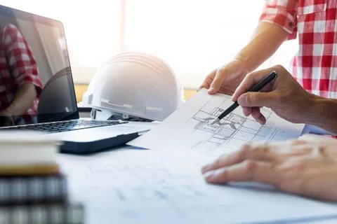 Architects engineer discussing at the table with blueprint - Closeup Stock Photos