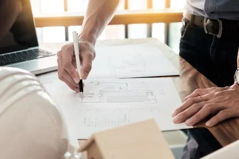 Architects engineer discussing at the table with blueprint - Closeup on hands Foto stock