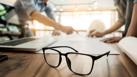 Architects engineer discussing at the table with blueprint - Closeup on hands Stock Photos