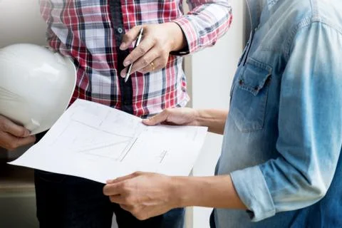 Architects engineer discussing at the table with blueprint - Closeup on hands Stock-Fotos