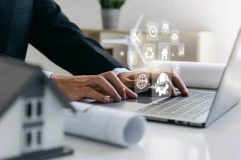 Architects engineer using laptop with eco home design. Stock Photos
