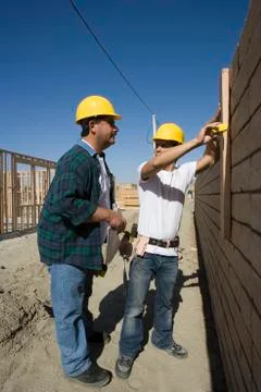 Architects Examining Brick Wall Stock Photos