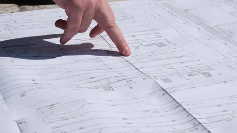 Architects going through a building plan Stock Footage 247994718