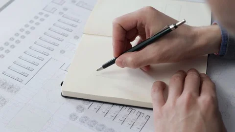 Architect's hands drawing a sketch in his notebook Stock Footage 125873140