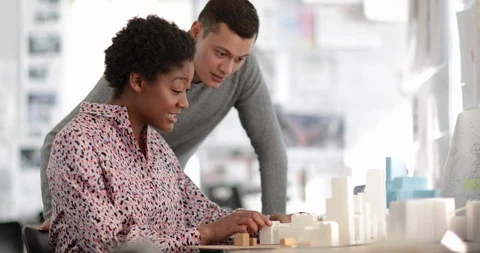 Architects looking at plans together Stock Footage 86880772