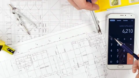 Architects make calculations with the help of a calculator and correct mistakes Vidéo 73676474