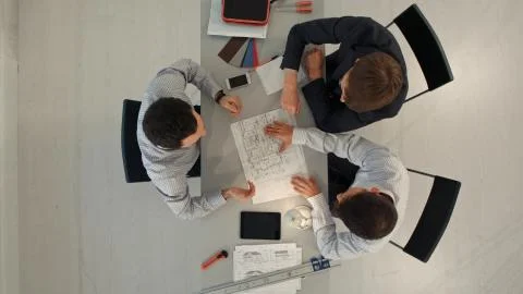 Architects in office looking at construction project. Top view Stock Photos