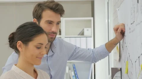 Architects in office working on construction project Stock Footage 57230750