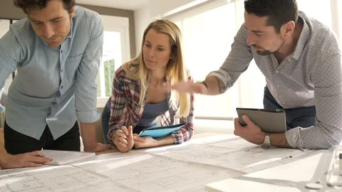Architects in office working on project Stock Footage 121456556