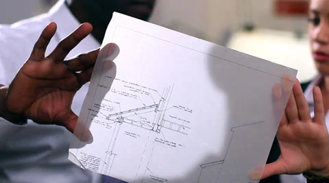 Architects or engineers in creative office looking at design plans. High quality Stockbeeldmateriaal 32749781