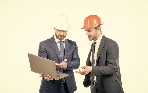 Architects planning work. chief engineer and executive in hardhat use computer. Stock Photos