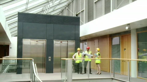 Architects with plans speaking about a building construction Stock-Footage 491011