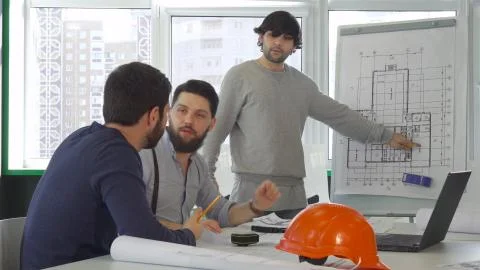 Architects point their hands on project of the building Stock Photos