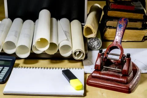 Architect's table, laptop, calculator on the table. Plans, projects and notep Stock Photos