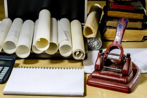 Architect's table, laptop, calculator on the table. Plans, projects and notep Stock Photos