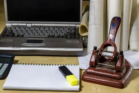 Architect's table, laptop, calculator on the table. Plans, projects and notep Stock Photos