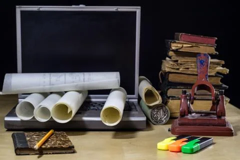 Architect's table, laptop, calculator on the table. Plans, projects and notep Stock Photos