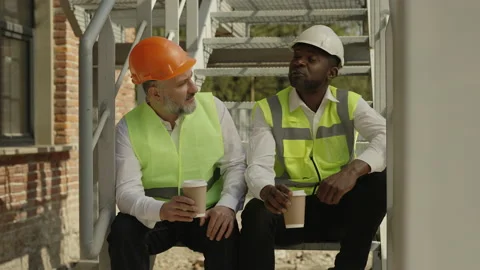 Architects taking coffee break while sitting at working area Stock Footage 196350054