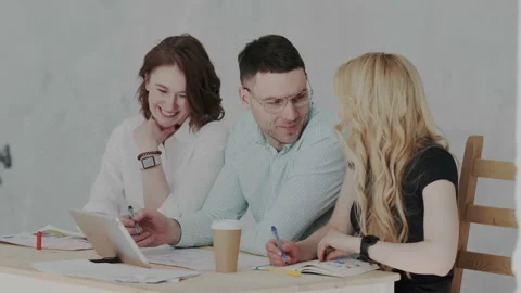 Architects team are working on paper blueprint and building model. using tablet Stock Footage 106200478