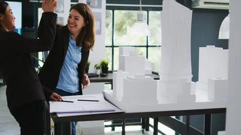 Architects team sharing high five after making progress Stock Photos