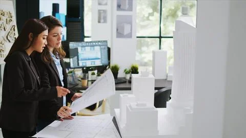 Architects team studying 3d printed building model in office Fotos de archivo