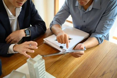 Architects team using digital tablet and discussing construction project at Stock Photos