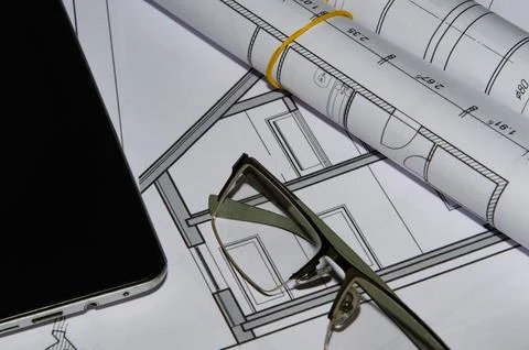 Architects work table with technical drawings and tablet computer Stock Photos