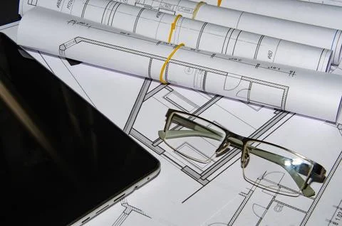 Architects work table with technical drawings and tablet computer Stock Photos