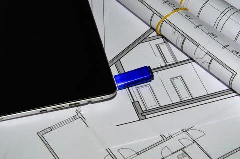 Architects work table with technical drawings and tablet computer Stock Photos
