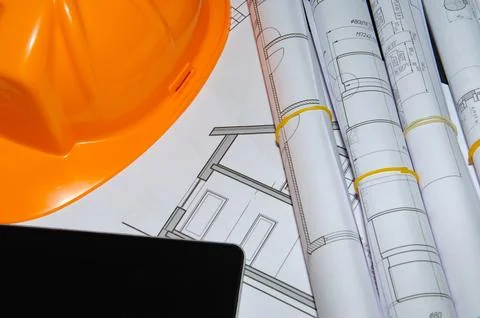 Architects work table with technical drawings and tablet computer Stock Photos