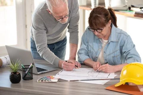 Architects working on blueprint Stock-Fotos