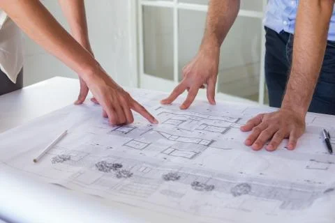 Architects working on blueprints together Stock Photos