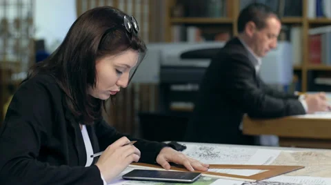 Architects working: female professionist at work with calculator: teamwork Stock-Footage 49775735