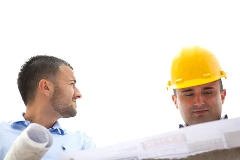 Architects working on their construction plan on the construction site Stock Photos