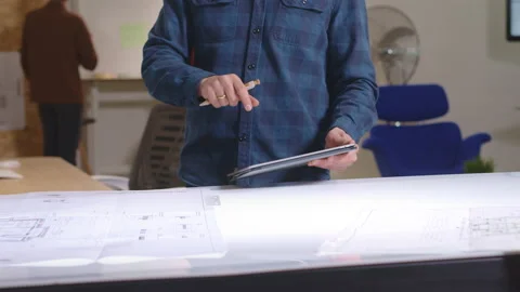 Architects working together in office with blueprints Stock Footage 149249291
