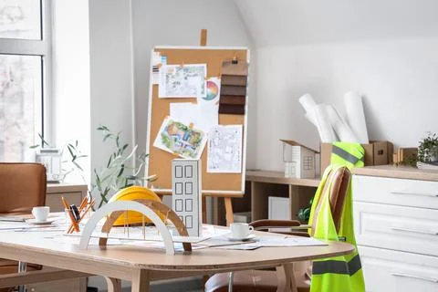 Architect's workplace with 3D models and coffee cup in office Stock Photos