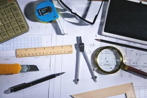 Architects workplace with architectural project plan and other objects. Stock Photos