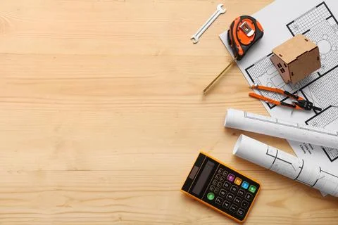 Architectural blueprint design with construction tools, calculator, and model Stock Photos