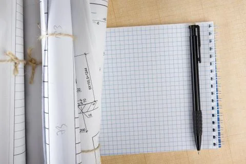 Architectural blueprints and blueprint rolls on white background Stock Photos