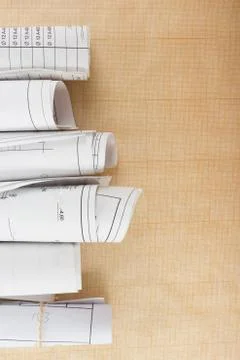 Architectural blueprints and blueprint rolls on white background Stock Photos