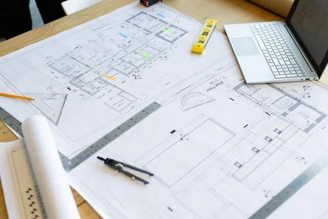 Architectural blueprints and drafting tools are on wooden table Stockfoto's